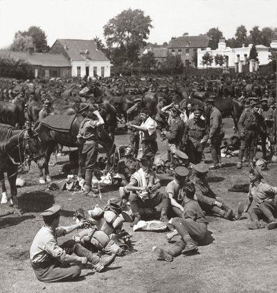 Cavalry, always ready in anticipation of a breakthrough, rest their horses in a French village by English Photographer
